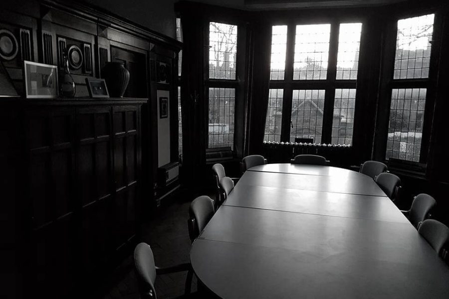 Old Haunted School room with large table surrounded by chairs